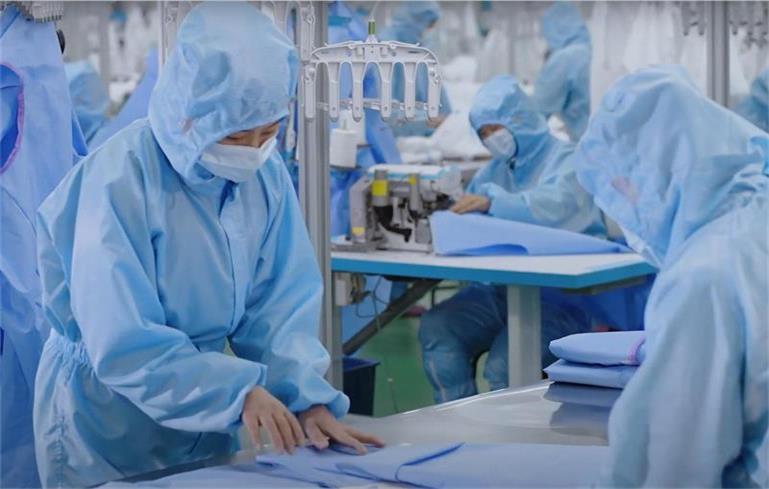 PPE factory workers sort out clothing products
