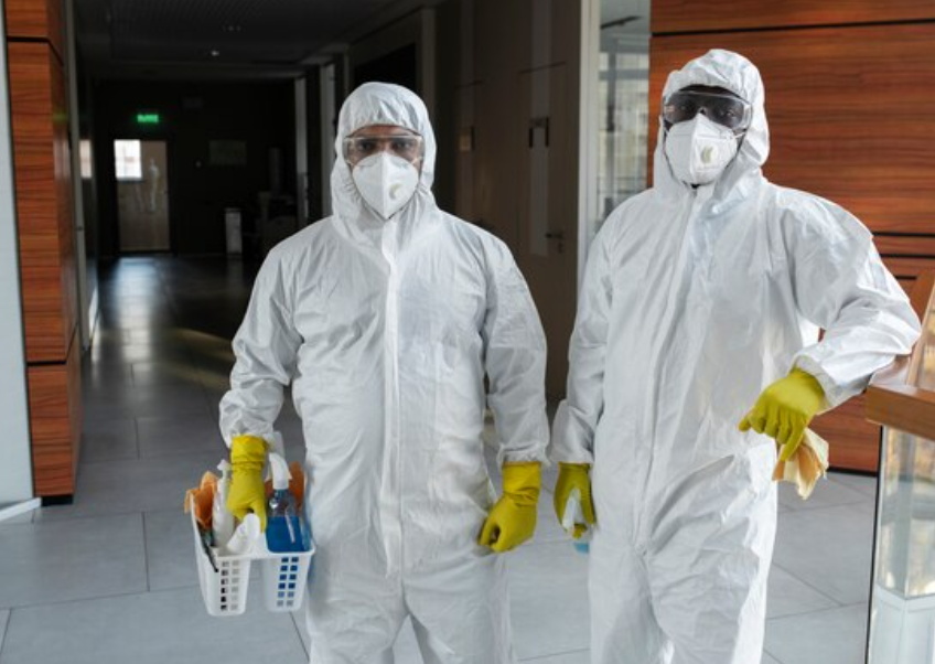 Staff wearing protective clothing cleaning