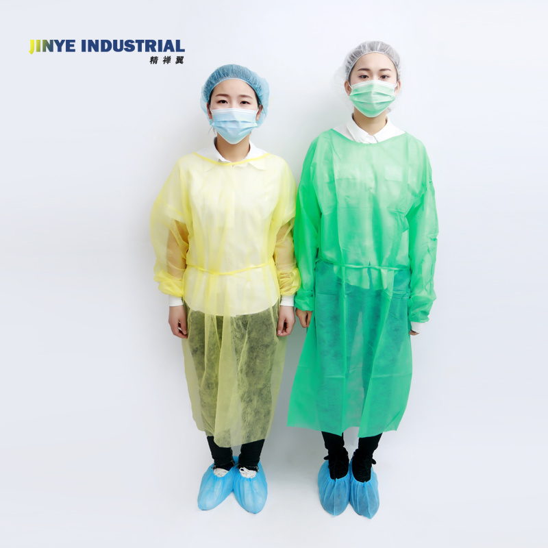 Two staff members wearing yellow and green isolation gowns