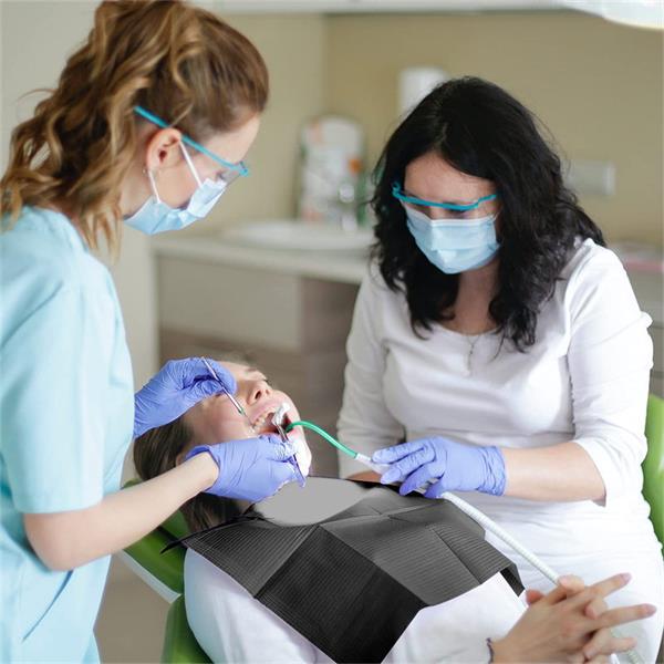 Dentist examining patient's teeth