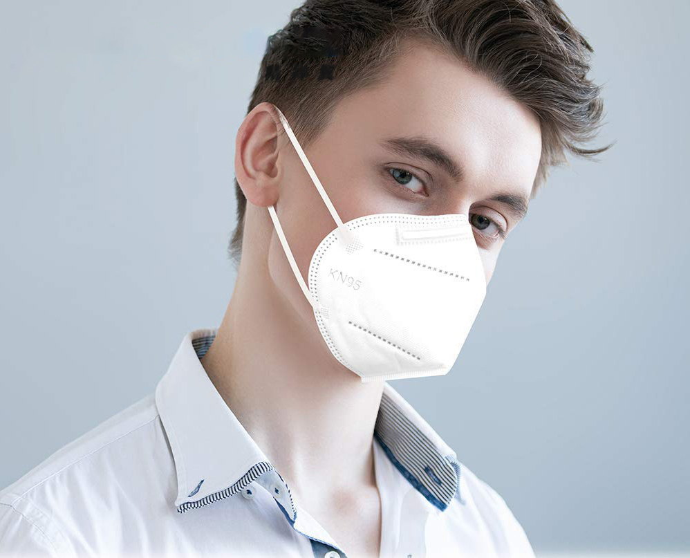 Boy wearing disposable white KN95 mask